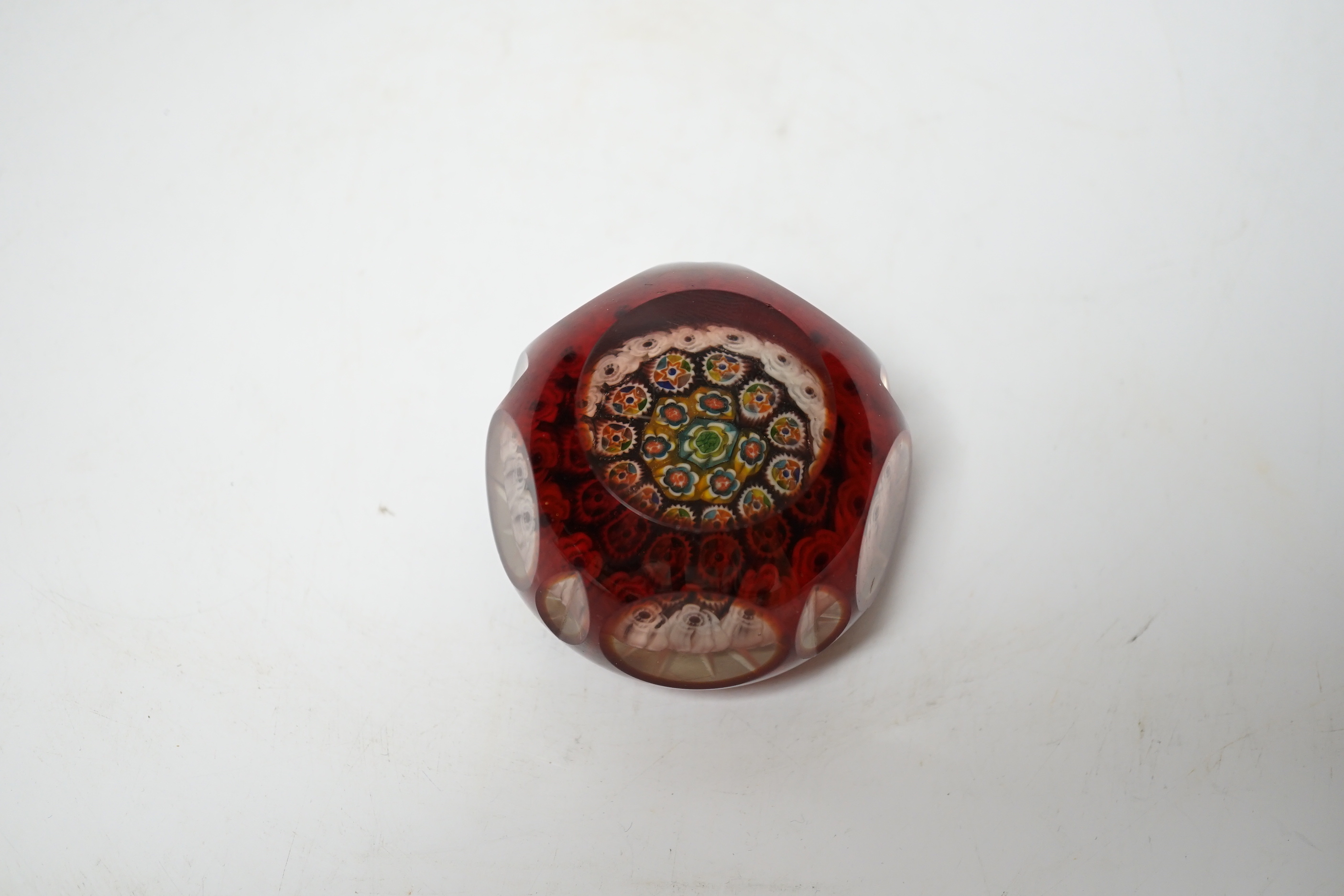 A 19th century ruby overlaid cut glass paperweight, 6cm diameter